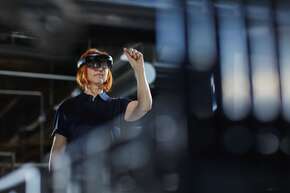 Woman in factory using AR_Brandmanual powerpoint.jpg