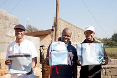 Raymond Phiri (centre), owner of Motion Bags and his team.jpg