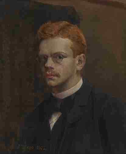 Portret młodego, rudowłosego mężczyzny w okularach.  