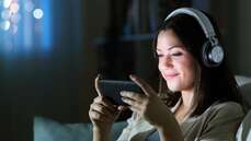 General - Woman with headphones watching video on smart phone_web.jpg