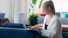 Woman in sofa working on her laptop_web.jpg