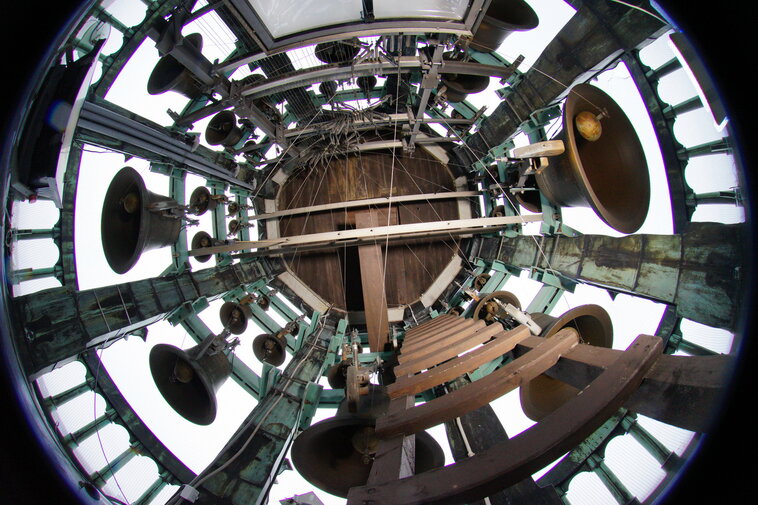 Zdjęcie przedstawia widok od dołu na dzwony carillonu i sklepienie szczytu wieży Ratusza.  