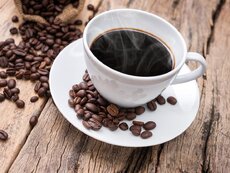 bigstock-Hot-Coffee-Cup-With-Coffee-Bea-237908515.jpg