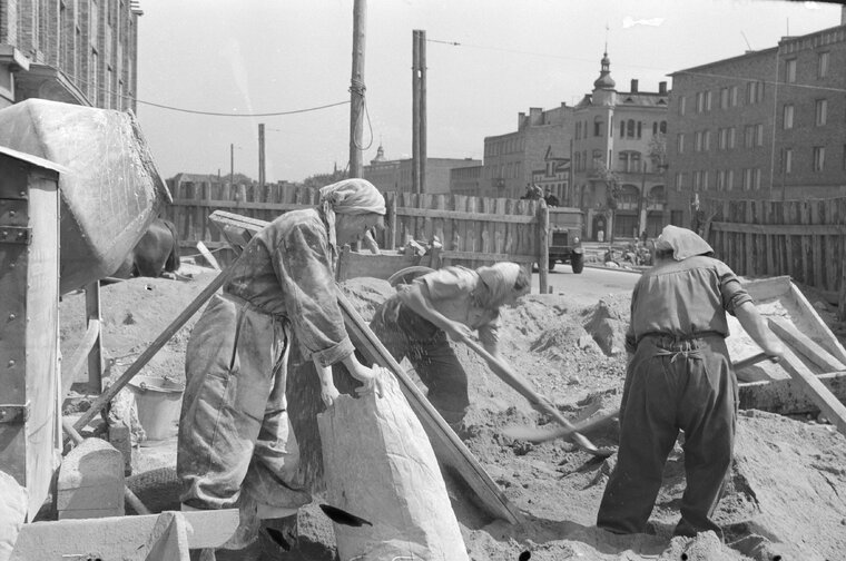 Ekipa kobieca kierowana przez Rozalię Bober podczas budowy GDM-u, po prawej widoczna kamienica z narożnym wykuszem w formie wieżyczki, 1951, zb. NAC