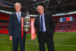 Sir-Tim-Clark-and-Greg-Dyke-stand-on-the-pitch-at-Wembley-Stadium-with-The-FA-Cup.jpg