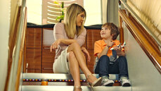 Jennifer Aniston and her young co-star Cooper onboard the A380 in the new Emirates TVC.jpg