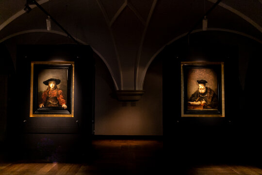 Girl in a Picture Frame and Scholar at His Writing Table_paintings_Rembrandt van Rijn