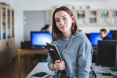 young-woman-standing-office
    
