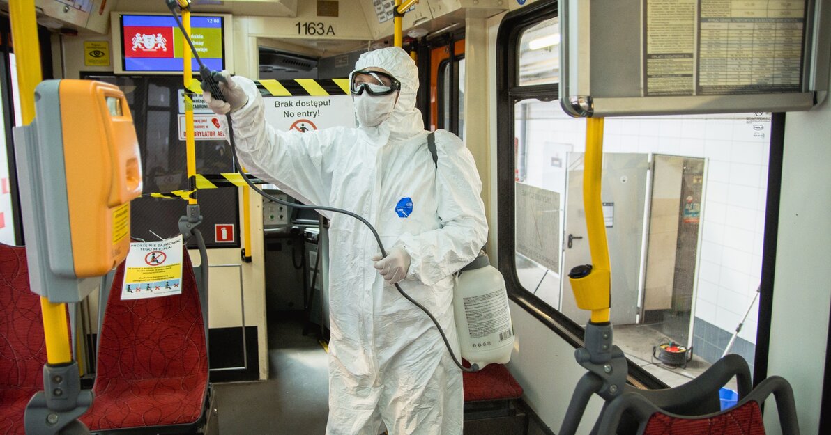 Osoba w kombinezonie dezynfekuje wnętrze tramwaju. Fot. Dominik Paszliński.jpg