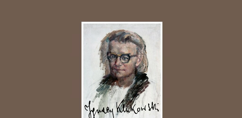 Na brązowym tle w białej obwódce narysowana postać mężczyzny w okularach. Na dole autograf, odręczne pismo Ignacy Klukowski. 