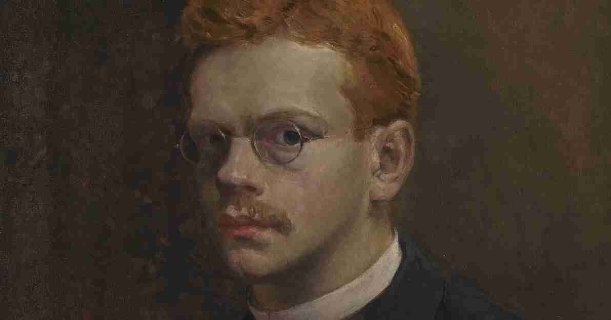Portret młodego, rudowłosego mężczyzny w okularach.  